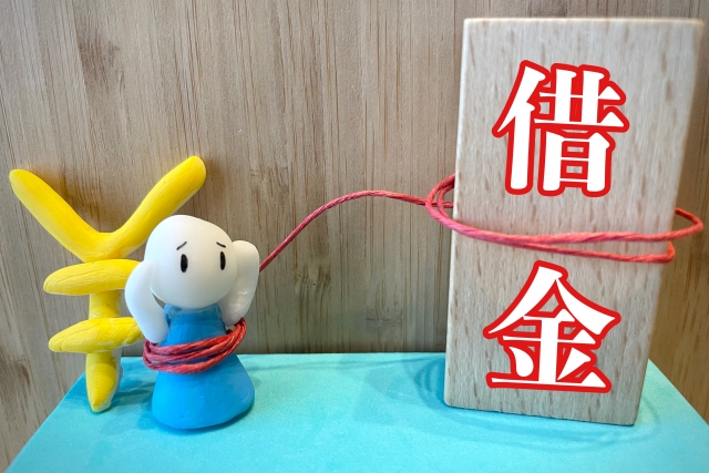 お金を手に頭を抱える。富士市で債務整理の無料相談ができます